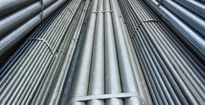 Various bundles of steel tubing and bar strapped together with bands.