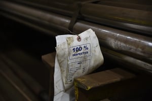 Paper tag on steel bar bundle reading 
