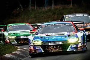 Three motorsport race cars driving on a track toward the viewer